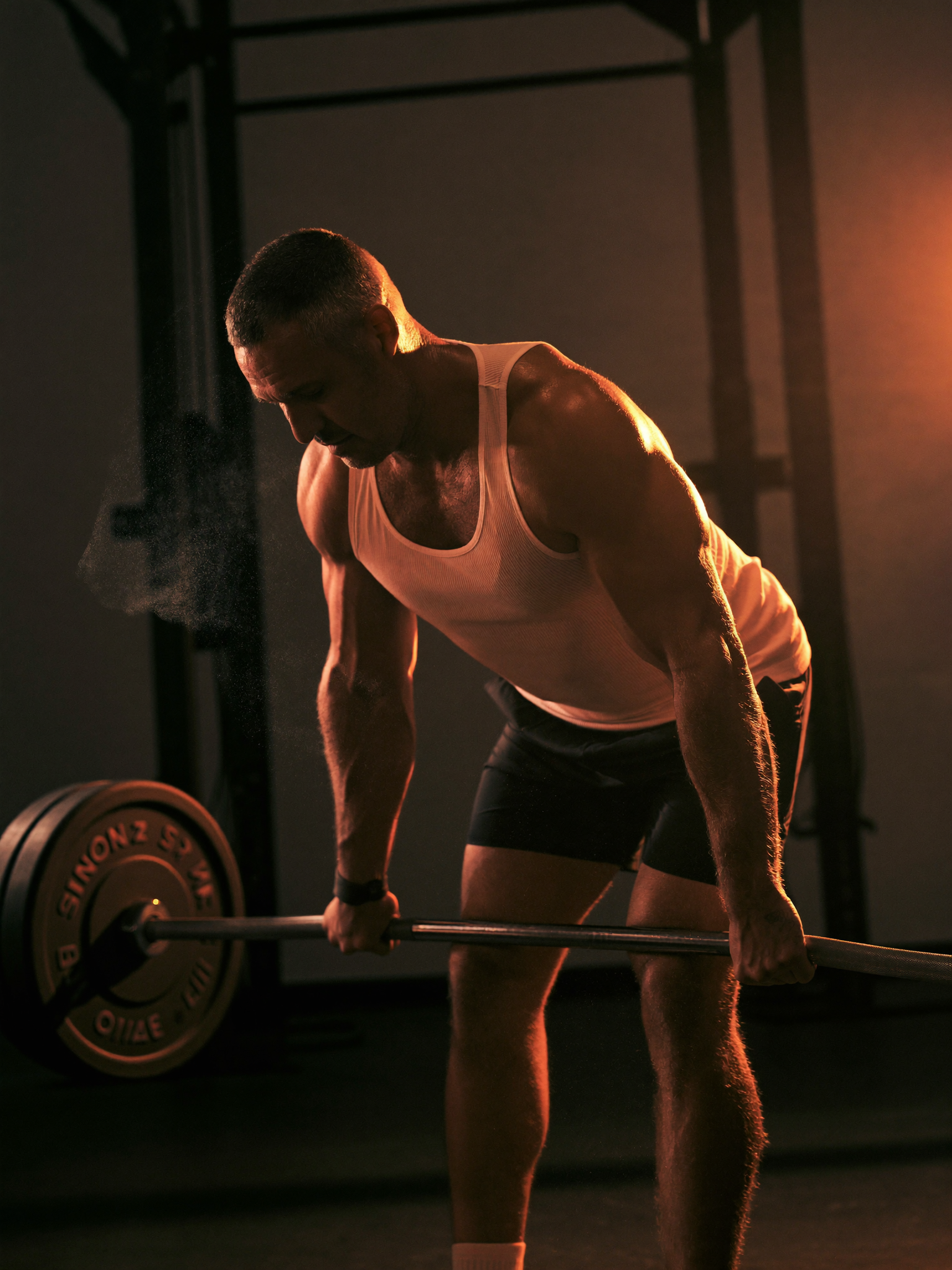 A man training under warm forge light